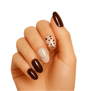 Brown chocolate and nude gel nail wraps with gold polka dots on hand