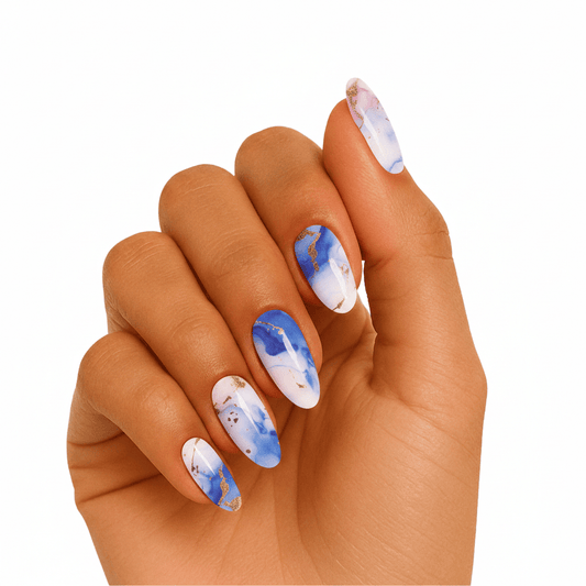 Blue marble gel nail wraps on hand with translucent stone pattern semi-cured design