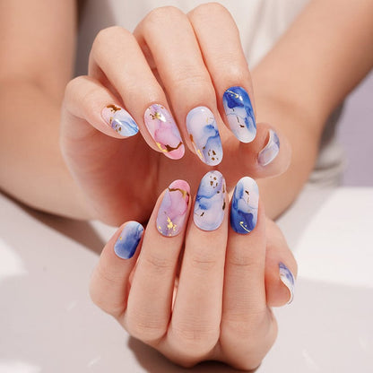 Abstract blue pink marble gel nail wraps artistic watercolour design on hands