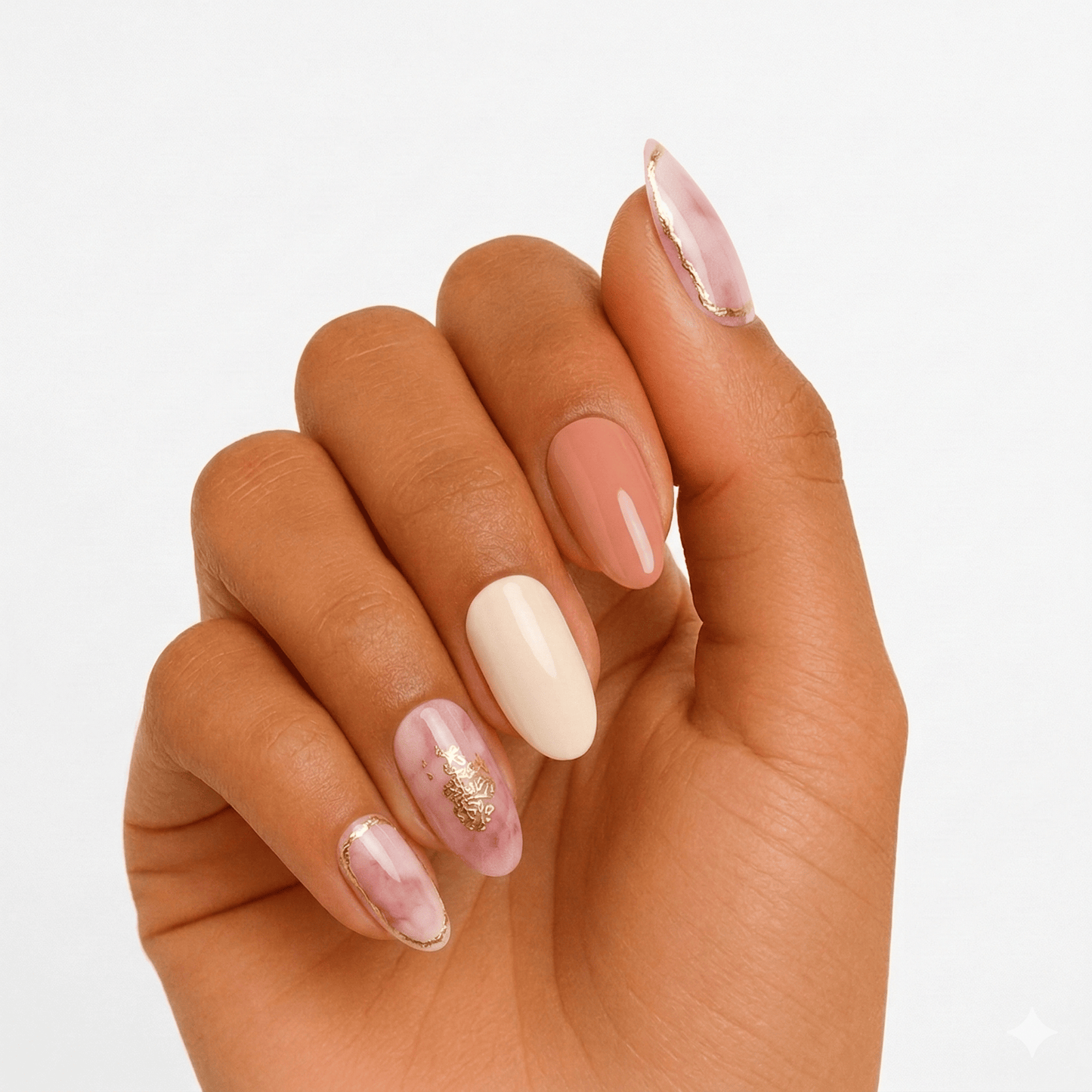 Pink cream gel nail wraps with gold foil accents on hand elegant manicure design