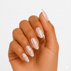 White lace pattern gel nail wraps on hand showing delicate bridal nail art
