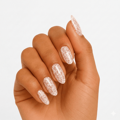 White lace pattern gel nail wraps on hand showing delicate bridal nail art