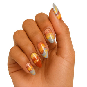 Hand wearing abstract orange gel nail wraps with flowing marble gradient design nail art