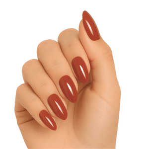 Glossy terracotta brown gel nail wraps on hand showing warm autumn manicure