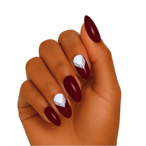 Deep burgundy gel nail wraps with white geometric accent design on hand