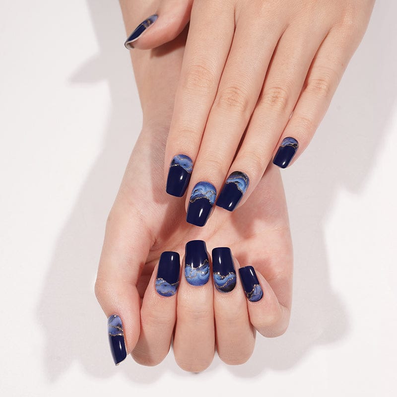 Navy blue gradient gel nails displayed on both hands with storm pattern