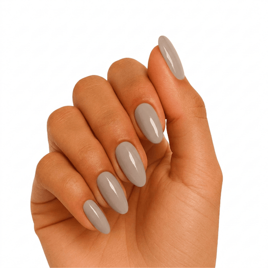 Taupe gel nail wraps on hand showing glossy neutral manicure finish
