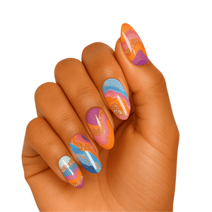 Multicoloured abstract gel nail wraps on hand featuring blue orange pink gold glitter swirls