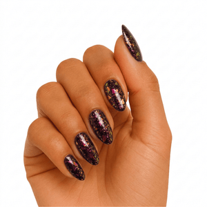 Dark holographic glitter gel nails on hand with rainbow sparkle finish and almond shape